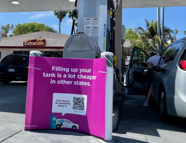 A sign at a Chevron gas station on First Avenue in San Diego about high gasoline prices, directing motorists to a QR code that links to the company's interpretation of why gas prices in California are so high. (Rob Nikolewski/San Diego Union-Tribune)